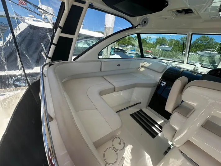  Yacht Photos Pics 2011 Pursuit OS 315 Offshore boat interior with white seating and helm station.