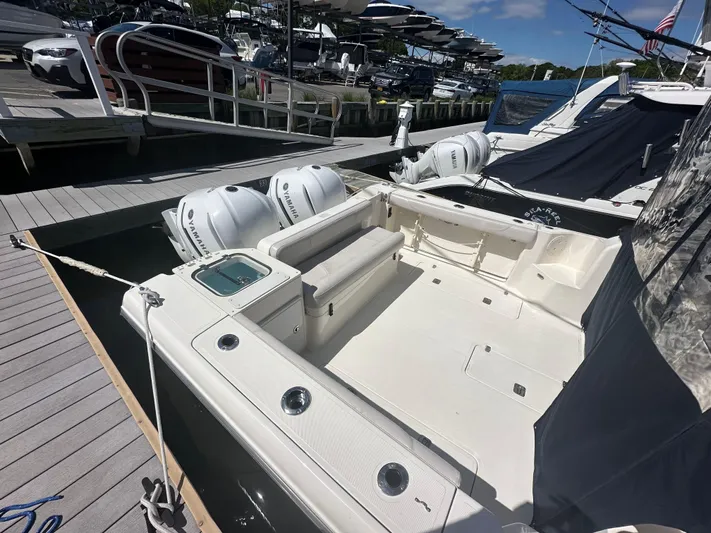  Yacht Photos Pics 2011 Pursuit OS 315 Offshore boat docked, featuring dual outboard engines and spacious deck area.