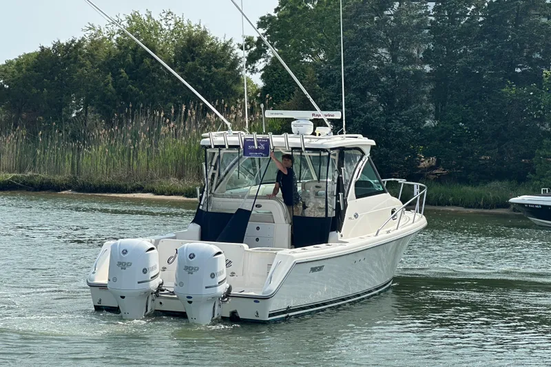  Yacht Photos Pics 2011 Pursuit OS 315 Offshore boat cruising on a calm waterway.