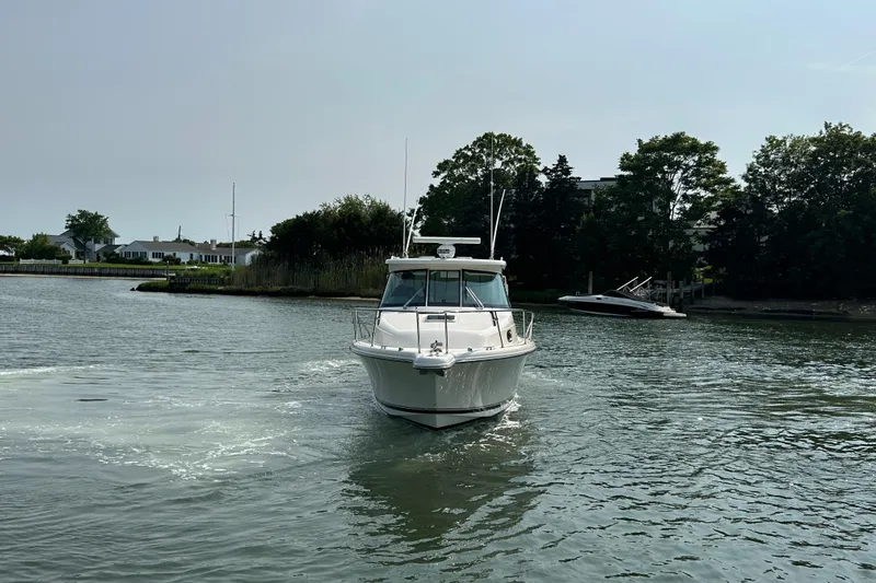  Yacht Photos Pics 2011 Pursuit OS 315 Offshore boat cruising on a calm waterway.