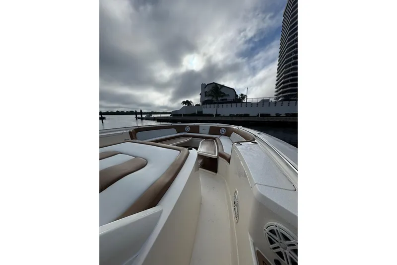  Yacht Photos Pics 2020 Scout 530 LXF boat interior with luxurious seating, docked near waterfront buildings.