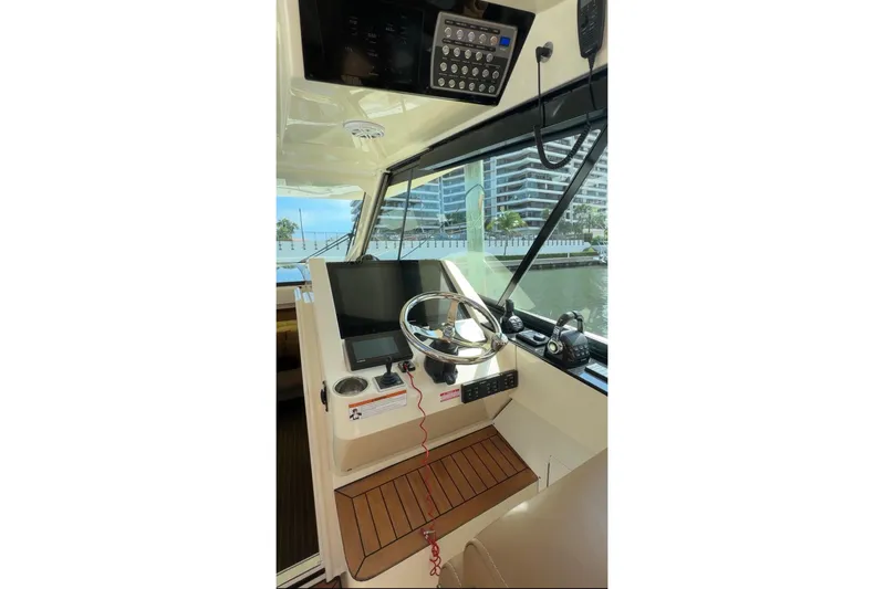  Yacht Photos Pics 2020 Scout 530 LXF boat helm with modern controls and waterfront view.