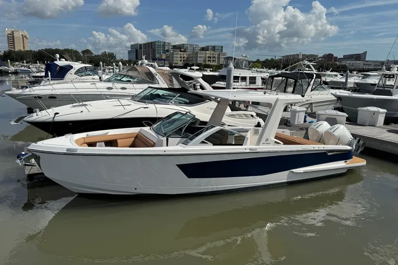  Yacht Photos Pics 2022 Aviara AV32 OB luxury boat docked in a marina under a partly cloudy sky.