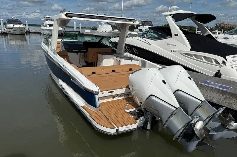  Yacht Photos Pics 2022 Aviara AV32 OB boat docked, featuring twin outboard engines and luxurious seating.