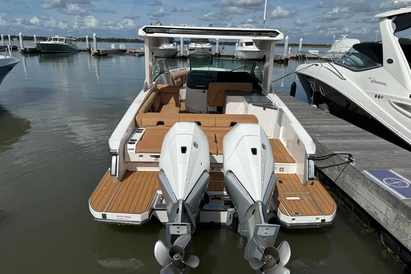  Yacht Photos Pics 2022 Aviara AV32 OB boat docked, featuring twin outboard engines and spacious seating.