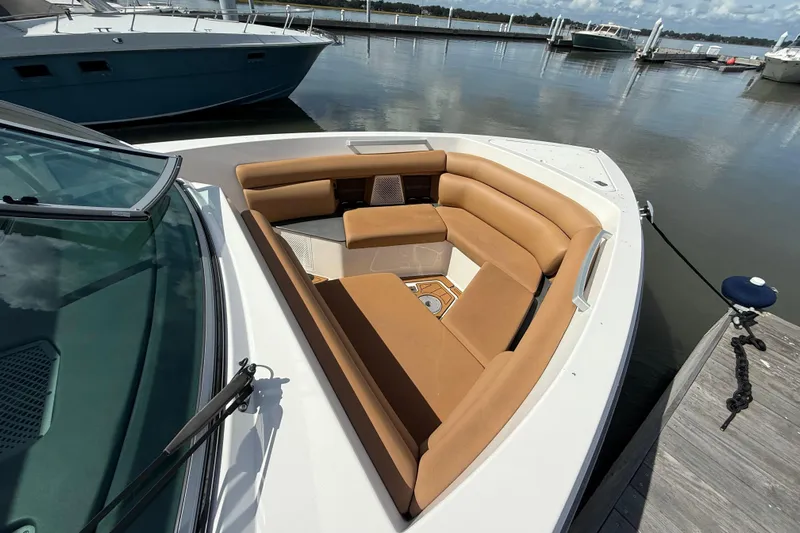  Yacht Photos Pics 2022 Aviara AV32 OB boat with tan seating, docked at a marina.