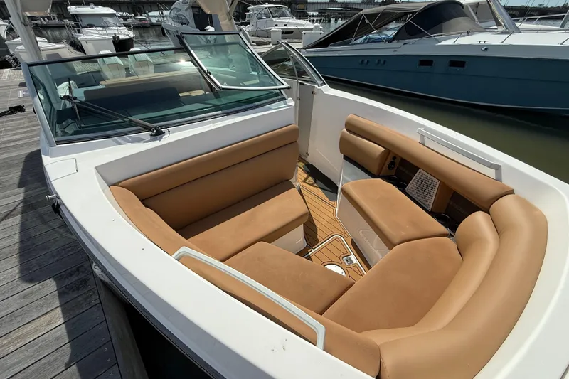  Yacht Photos Pics 2022 Aviara AV32 OB boat with tan seating, docked at a marina.