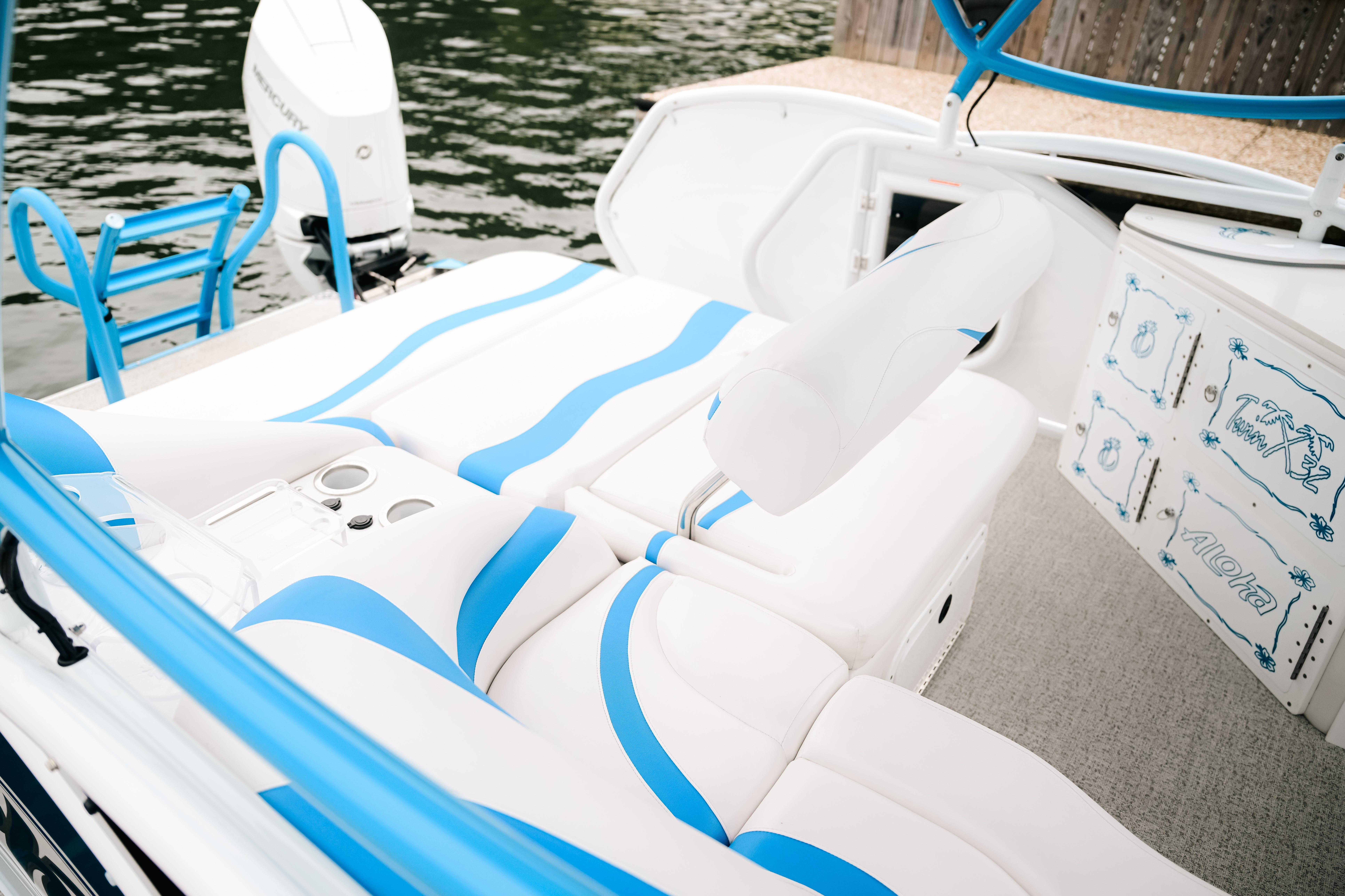 Luxurious interior of 2026 Aloha Pontoon Paradise Twin X32 with blue and white seating.