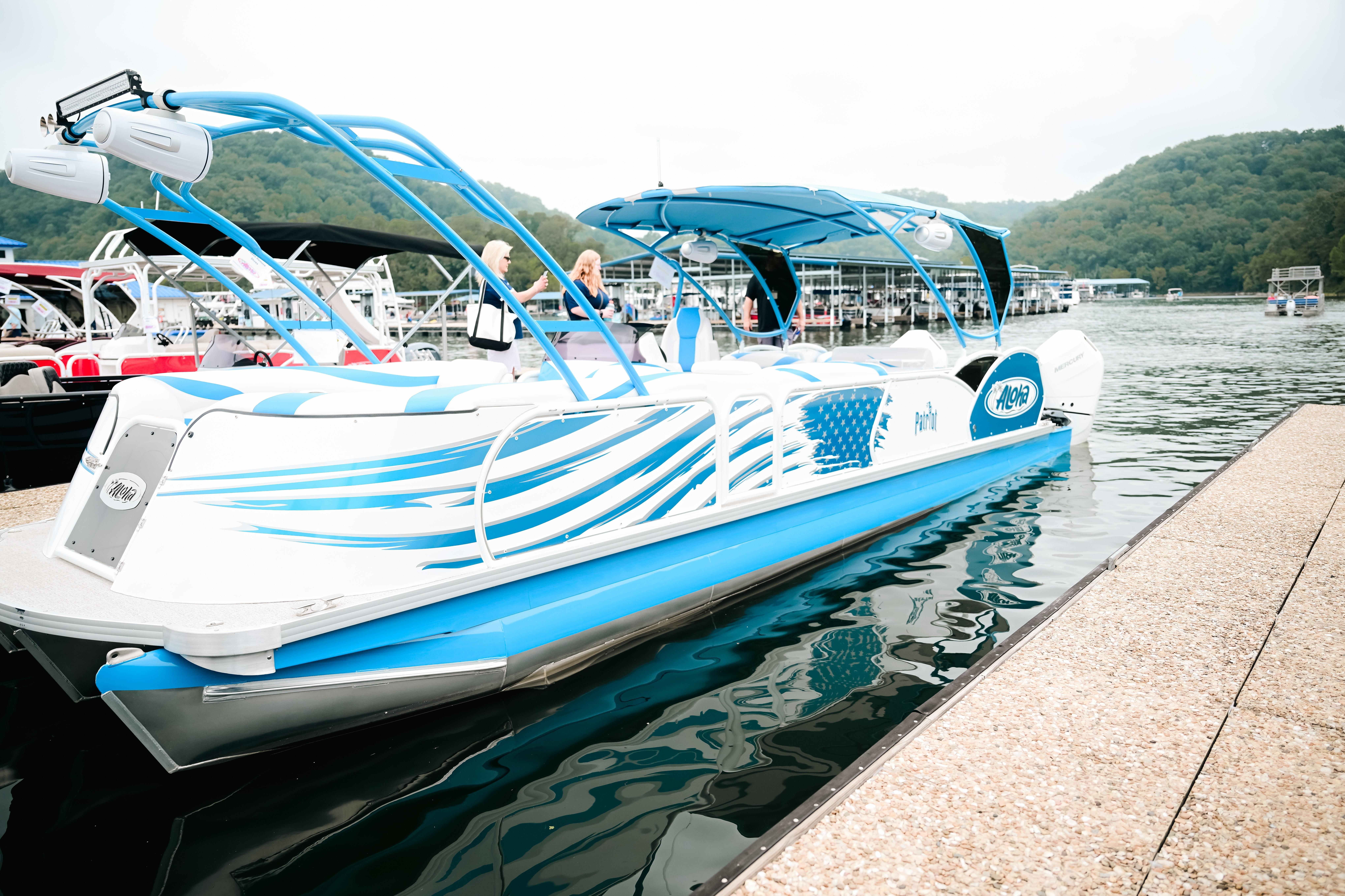 2026 Aloha Pontoon Paradise Twin X32 docked on a scenic lake.