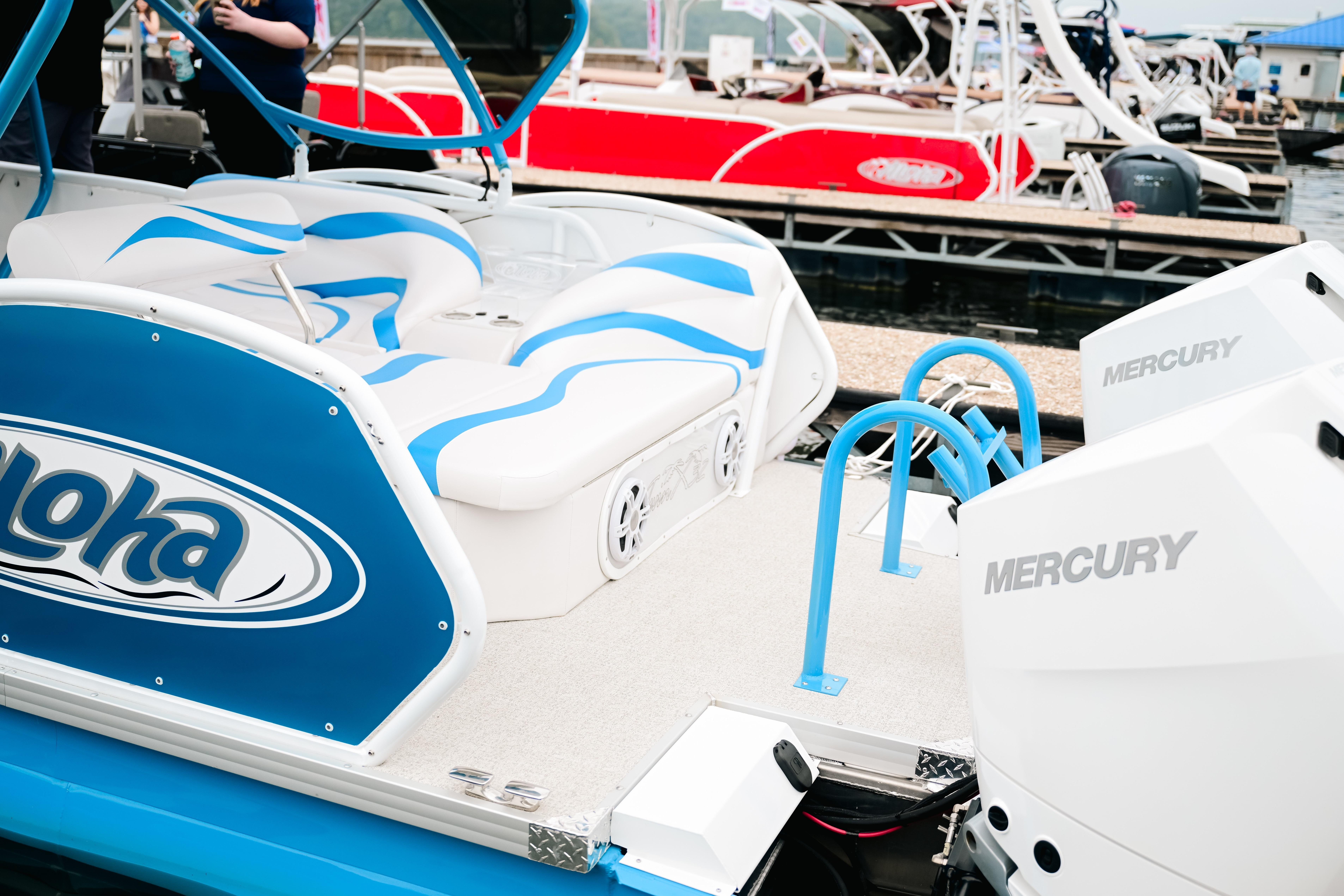 2026 Aloha Pontoon Paradise Twin X32 with Mercury engines at a marina dock.