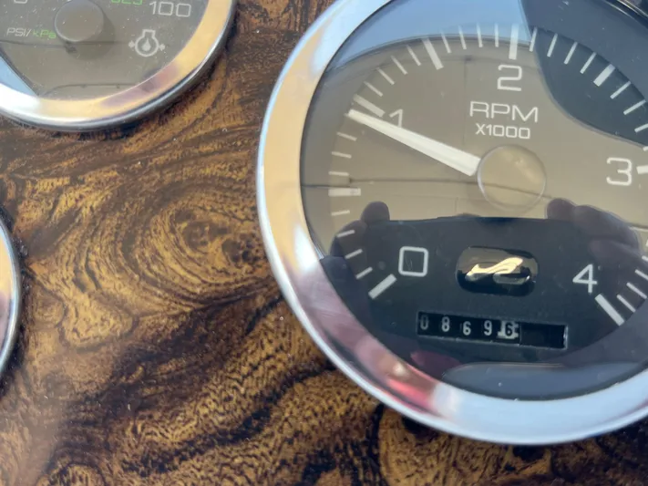  Yacht Photos Pics Close-up of 1997 Sea Ray 420 Aft Cabin RPM gauge on wooden dashboard.