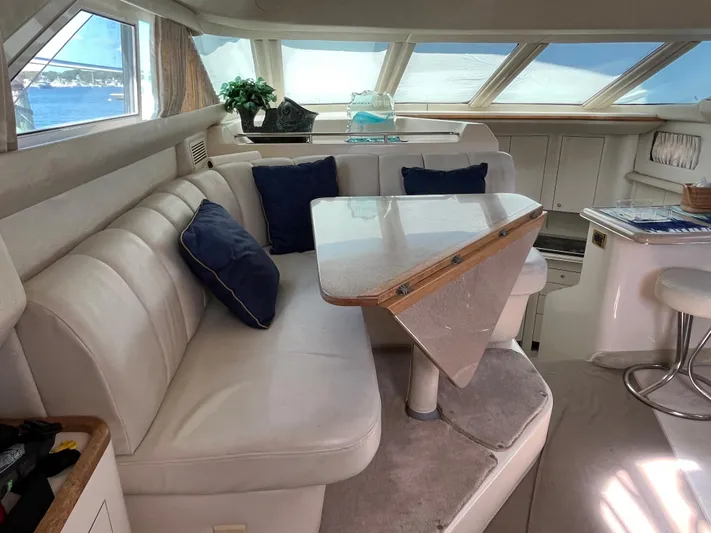  Yacht Photos Pics 1997 Sea Ray 420 Aft Cabin interior with white leather seating and dining table.