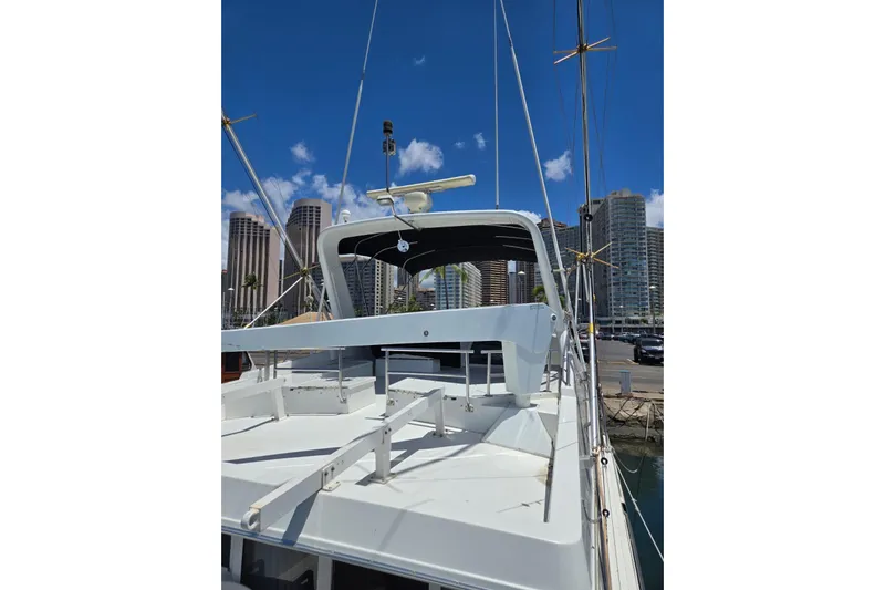  Yacht Photos Pics 1994 Navigator 5600 yacht docked in marina with city skyline background.