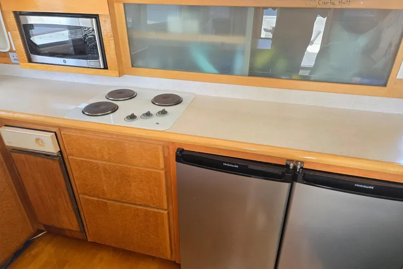 Yacht Photos Pics Kitchen area of a 1994 Navigator 5600 with stove, microwave, and dual Frigidaire refrigerators.