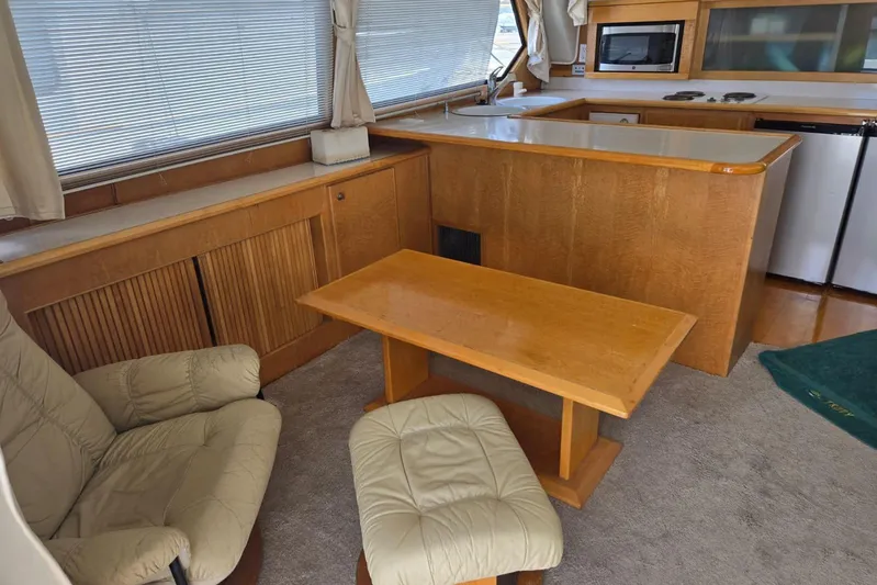  Yacht Photos Pics Cozy interior of a 1994 Navigator 5600 yacht with kitchen and seating area.