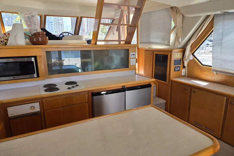  Yacht Photos Pics Interior of 1994 Navigator 5600 yacht kitchen with appliances and wooden cabinetry.