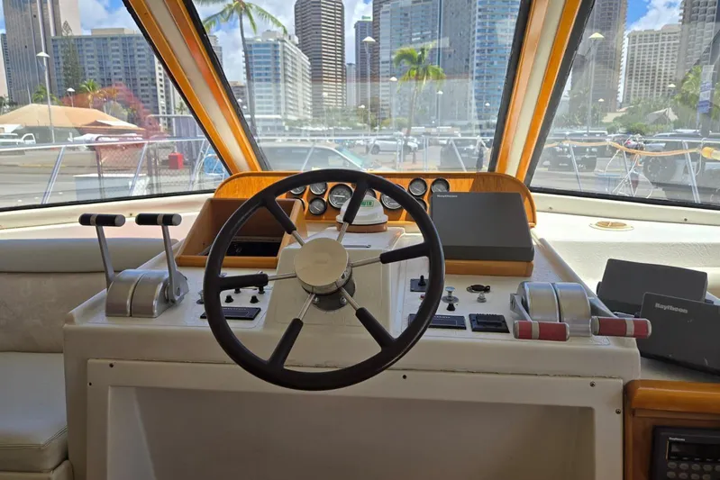  Yacht Photos Pics 1994 Navigator 5600 yacht helm with city skyline view through windows.