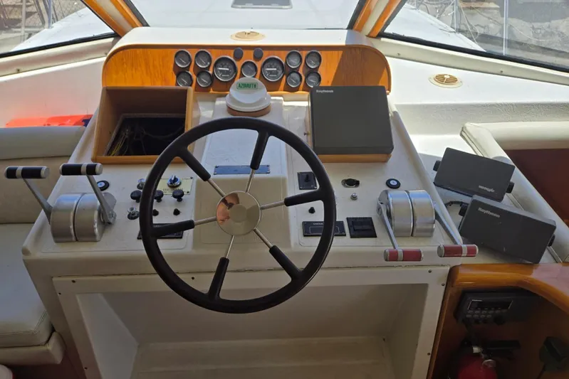  Yacht Photos Pics 1994 Navigator 5600 yacht helm with steering wheel, controls, and navigation equipment.