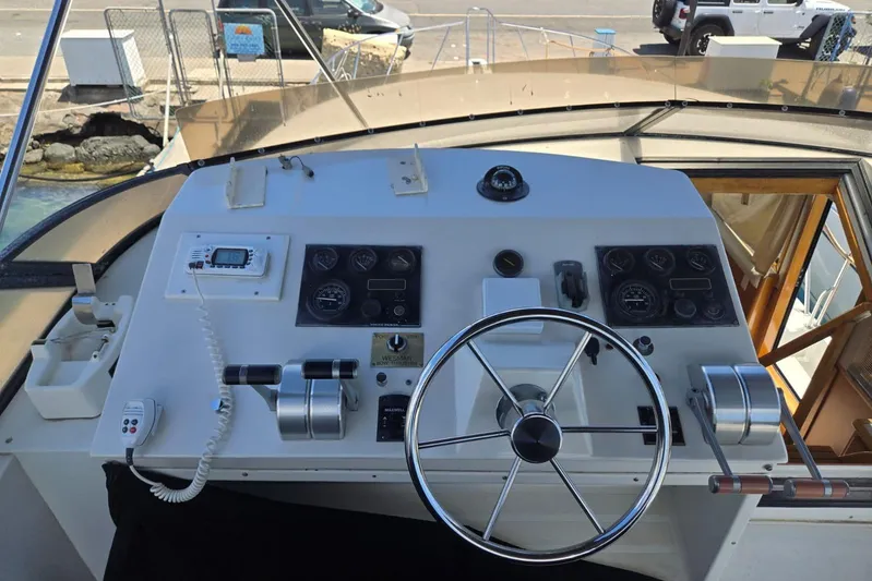  Yacht Photos Pics Control panel of a 1994 Navigator 5600 yacht with steering wheel and navigation instruments.