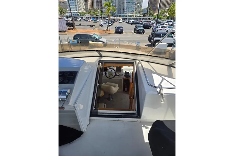  Yacht Photos Pics 1994 Navigator 5600 yacht interior view with steering wheel and marina background.