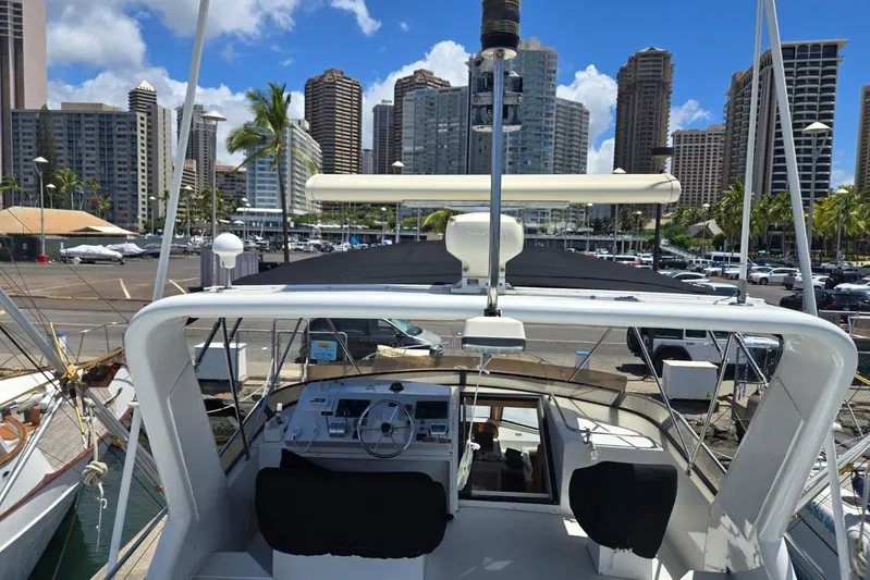  Yacht Photos Pics Navigator 5600 yacht docked in urban marina, city skyline in background, sunny day, 1994 model.