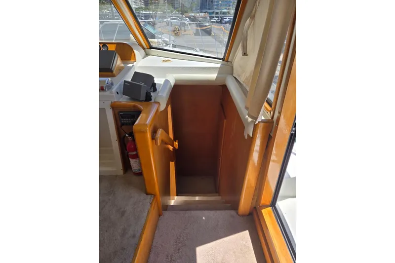  Yacht Photos Pics Interior of 1994 Navigator 5600 yacht showing stairs and helm area.