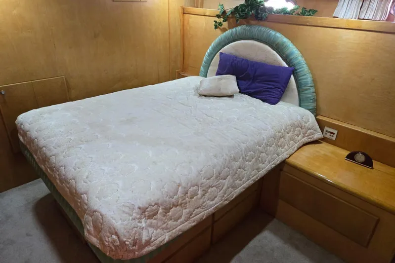  Yacht Photos Pics Cozy bedroom in 1994 Navigator 5600 yacht with plush bedding and wooden accents.