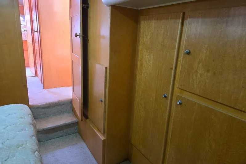  Yacht Photos Pics Interior of 1994 Navigator 5600 yacht with wooden cabinets and carpeted steps.