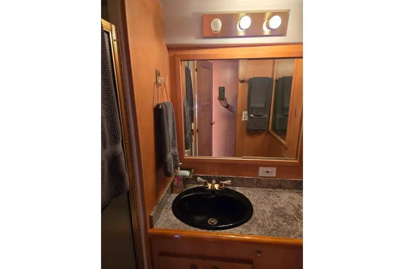  Yacht Photos Pics Bathroom vanity with mirror and black sink in 1994 Navigator 5600 model.
