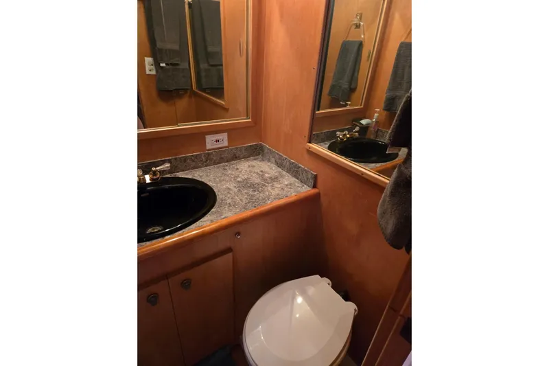  Yacht Photos Pics Bathroom interior of a 1994 Navigator 5600 with black sink and marble countertop.