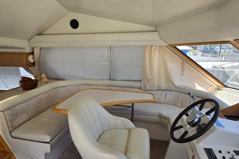  Yacht Photos Pics 1994 Navigator 5600 yacht interior with steering wheel, seating area, and windows.