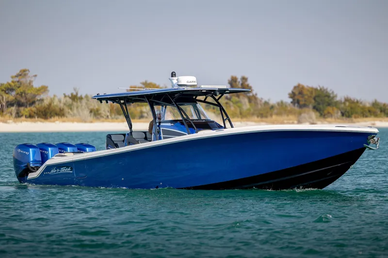  Yacht Photos Pics 2020 Nor-Tech 390 Sport Center Console boat cruising on water, featuring a sleek blue design.