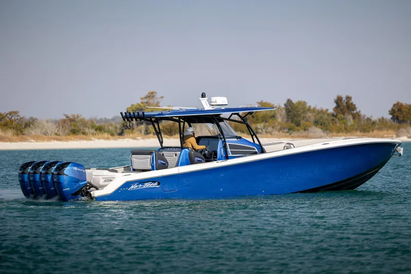  Yacht Photos Pics 2020 Nor-Tech 390 Sport Center Console boat cruising on water, featuring blue hull and multiple engines.