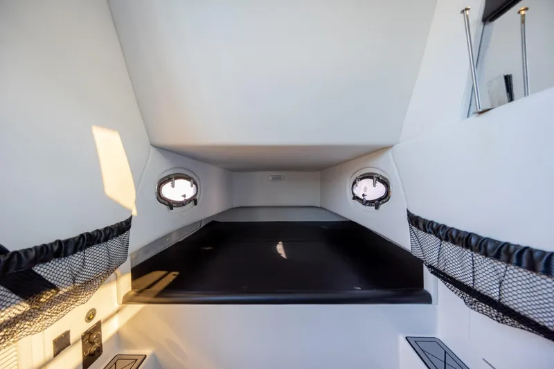  Yacht Photos Pics 2020 Nor-Tech 390 Sport Center Console cabin interior with portholes and storage nets.