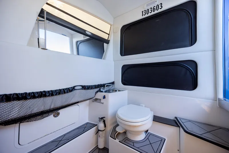  Yacht Photos Pics 2020 Nor-Tech 390 Sport Center Console boat interior with toilet and storage.