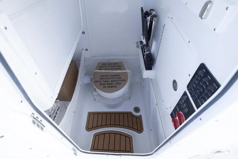  Yacht Photos Pics Interior of 2026 Sea Hunt Ultra 275 SE boat, featuring a compact marine toilet.