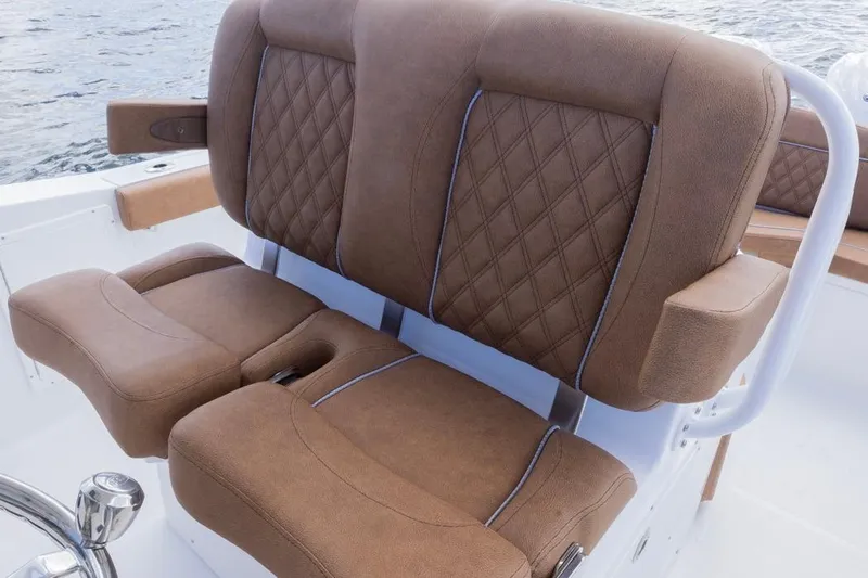  Yacht Photos Pics Luxurious seating on 2026 Sea Hunt Ultra 275 SE boat, featuring brown diamond-stitched upholstery.