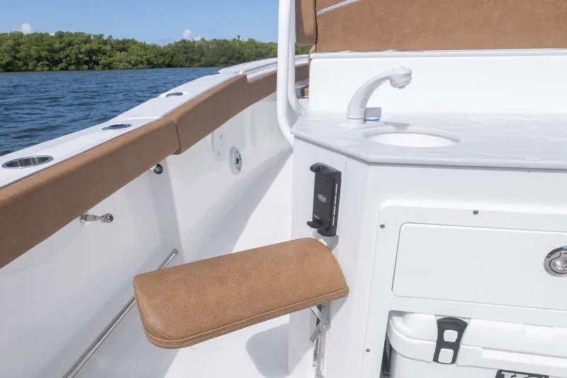  Yacht Photos Pics 2026 Sea Hunt Ultra 275 SE boat interior with seating and sink, on calm water.