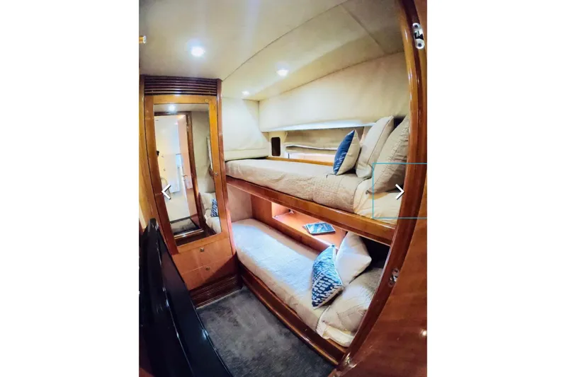  Yacht Photos Pics Interior of 2006 Sunseeker Predator 82 yacht with cozy bunk beds and wooden finish.