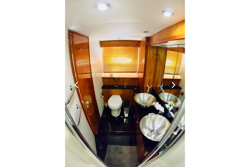  Yacht Photos Pics Luxurious bathroom in 2006 Sunseeker Predator 82 yacht with modern fixtures and wooden accents.