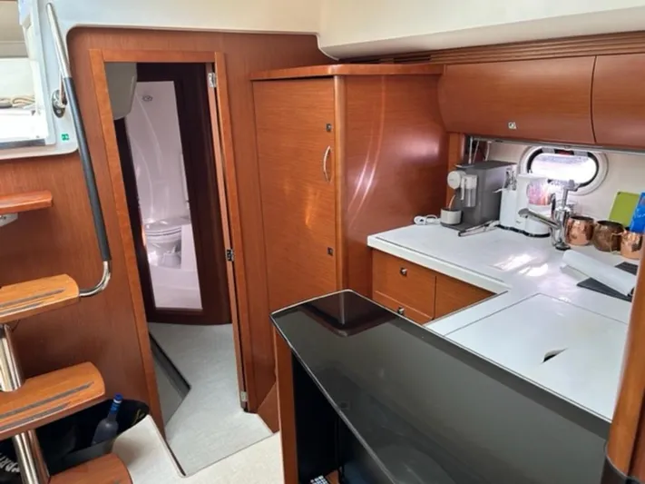 Yacht Photos Pics Interior of 2012 Prestige 440 S yacht with modern kitchen and wooden cabinetry.