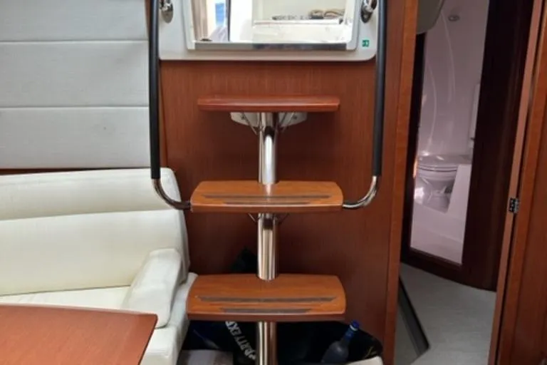  Yacht Photos Pics Interior of 2012 Prestige 440 S yacht with wooden steps and seating area.