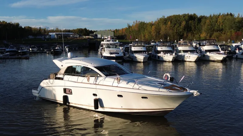  Yacht Photos Pics Luxury 2012 Prestige 440 S yacht docked in a serene marina setting.