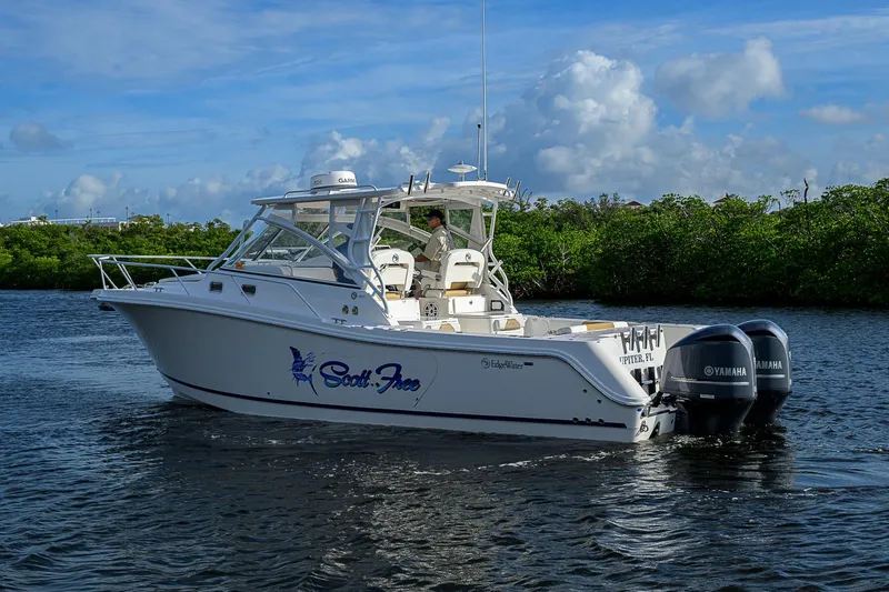  Yacht Photos Pics 2016 Edgewater 335 Express boat on water with twin Yamaha engines.
