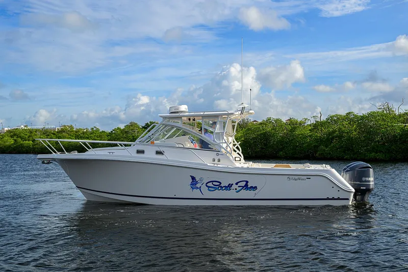  Yacht Photos Pics 2016 Edgewater 335 Express boat on water, clear sky background.