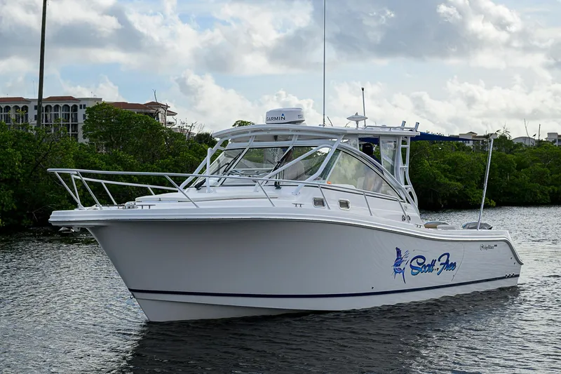  Yacht Photos Pics 2016 Edgewater 335 Express boat on water, cloudy sky background.