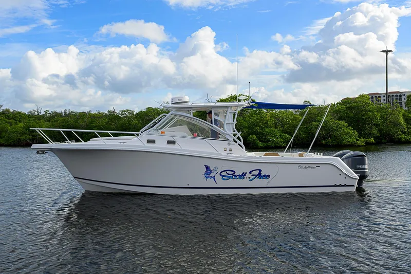  Yacht Photos Pics 2016 Edgewater 335 Express boat on calm water under a partly cloudy sky.