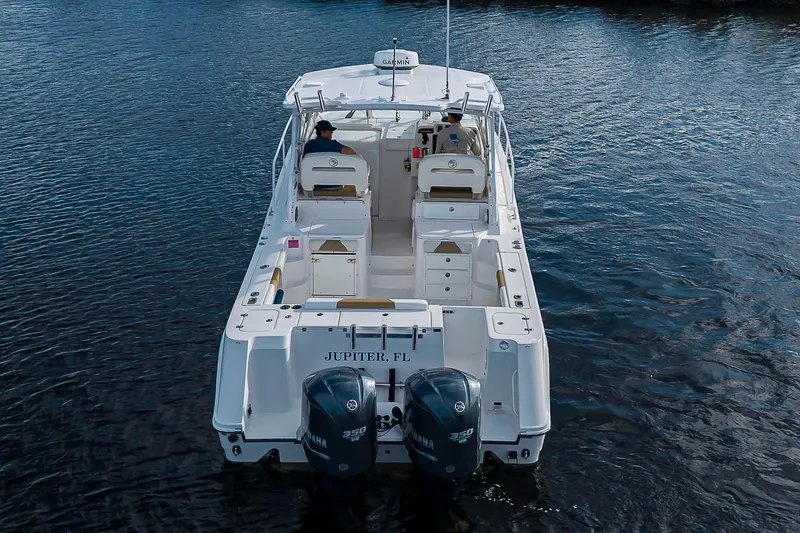 Yacht Photos Pics 2016 Edgewater 335 Express boat on water, rear view, with dual Yamaha engines.
