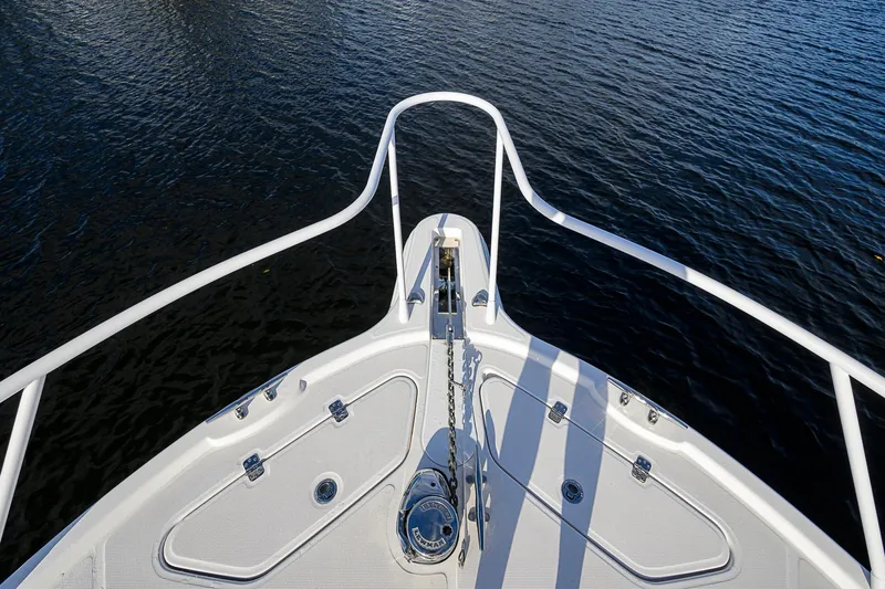  Yacht Photos Pics Bow view of 2016 Edgewater 335 Express boat on water.