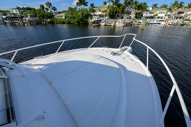  Yacht Photos Pics Bow view of 2016 Edgewater 335 Express boat docked by waterfront homes.